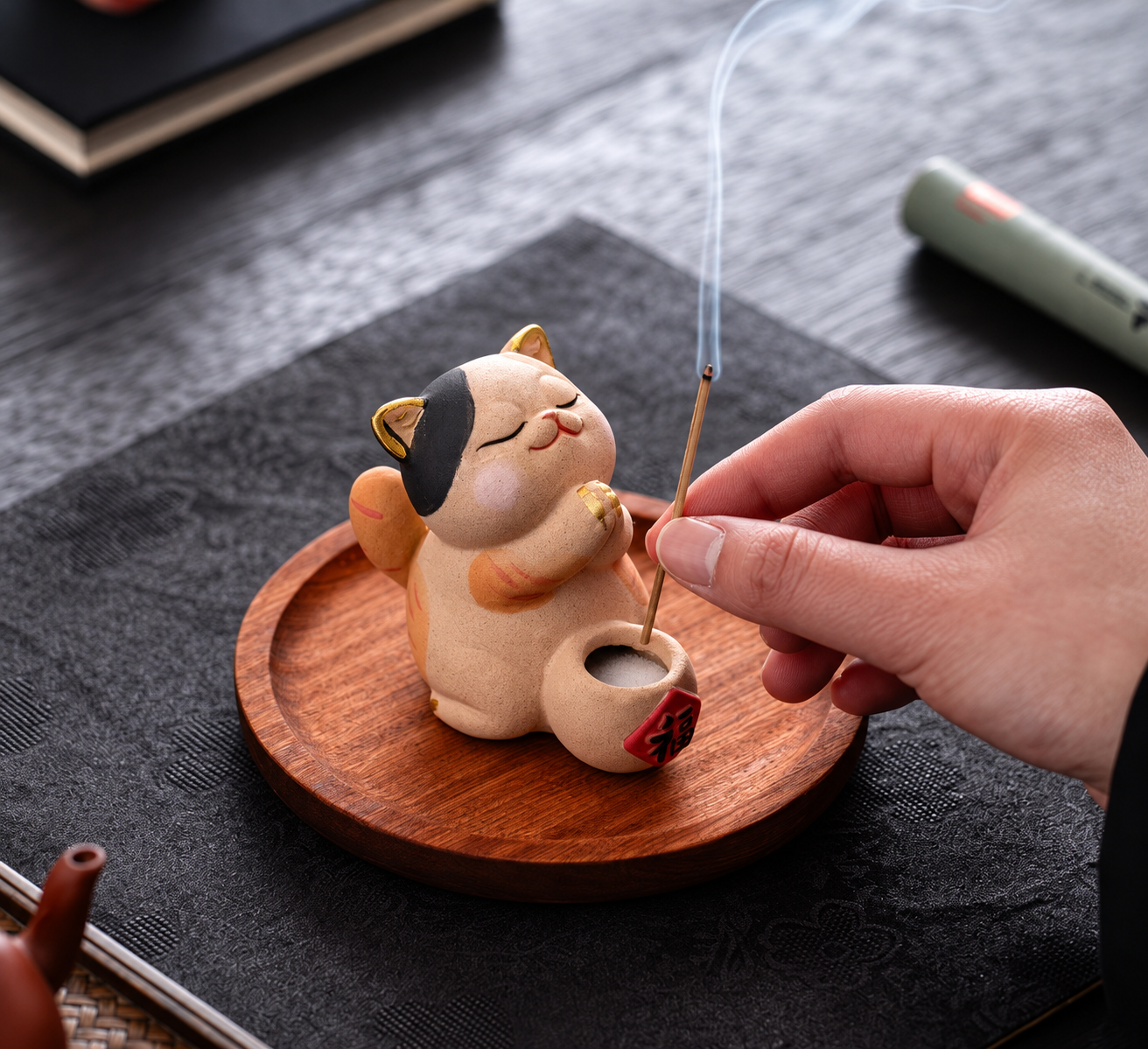 Ceramic lucky cat incense holder shown on a wooden tray. Image edited from seller reference.